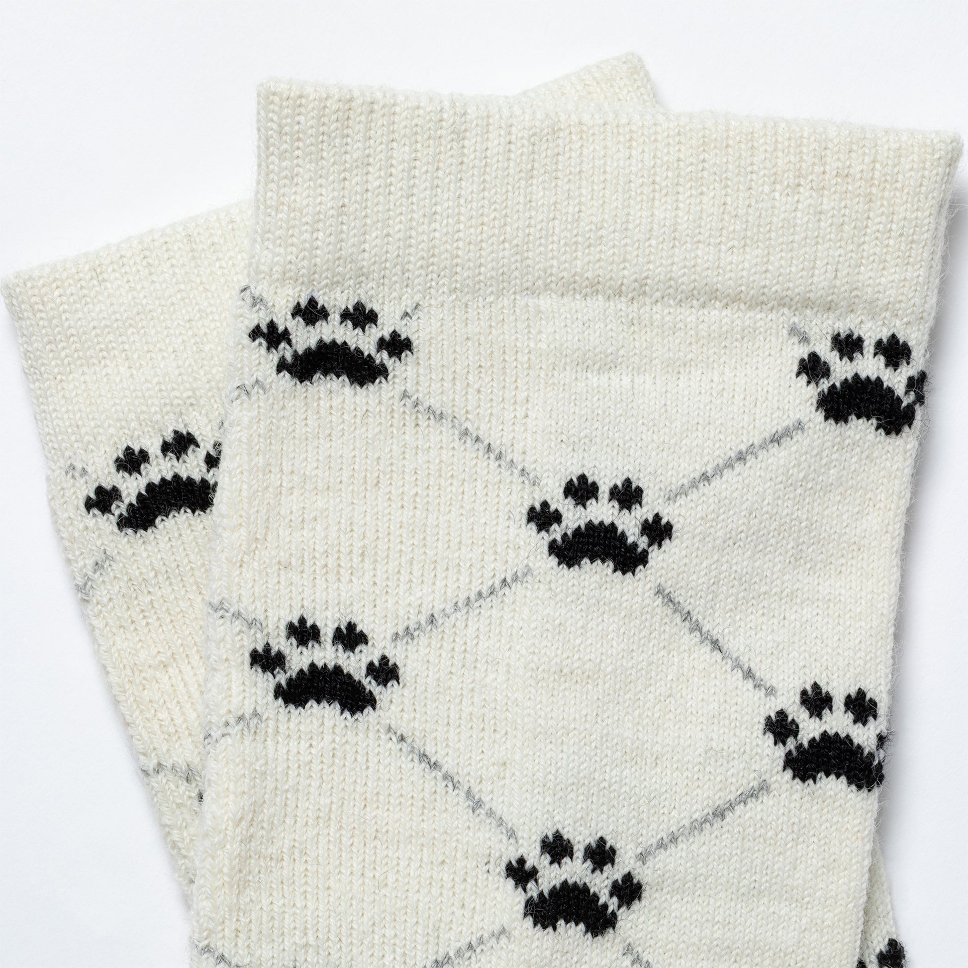 White socks with black paw print pattern on a white background