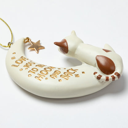 Cat-shaped ornament on a crescent moon with 'I love you to the moon and back' text, on a white background.