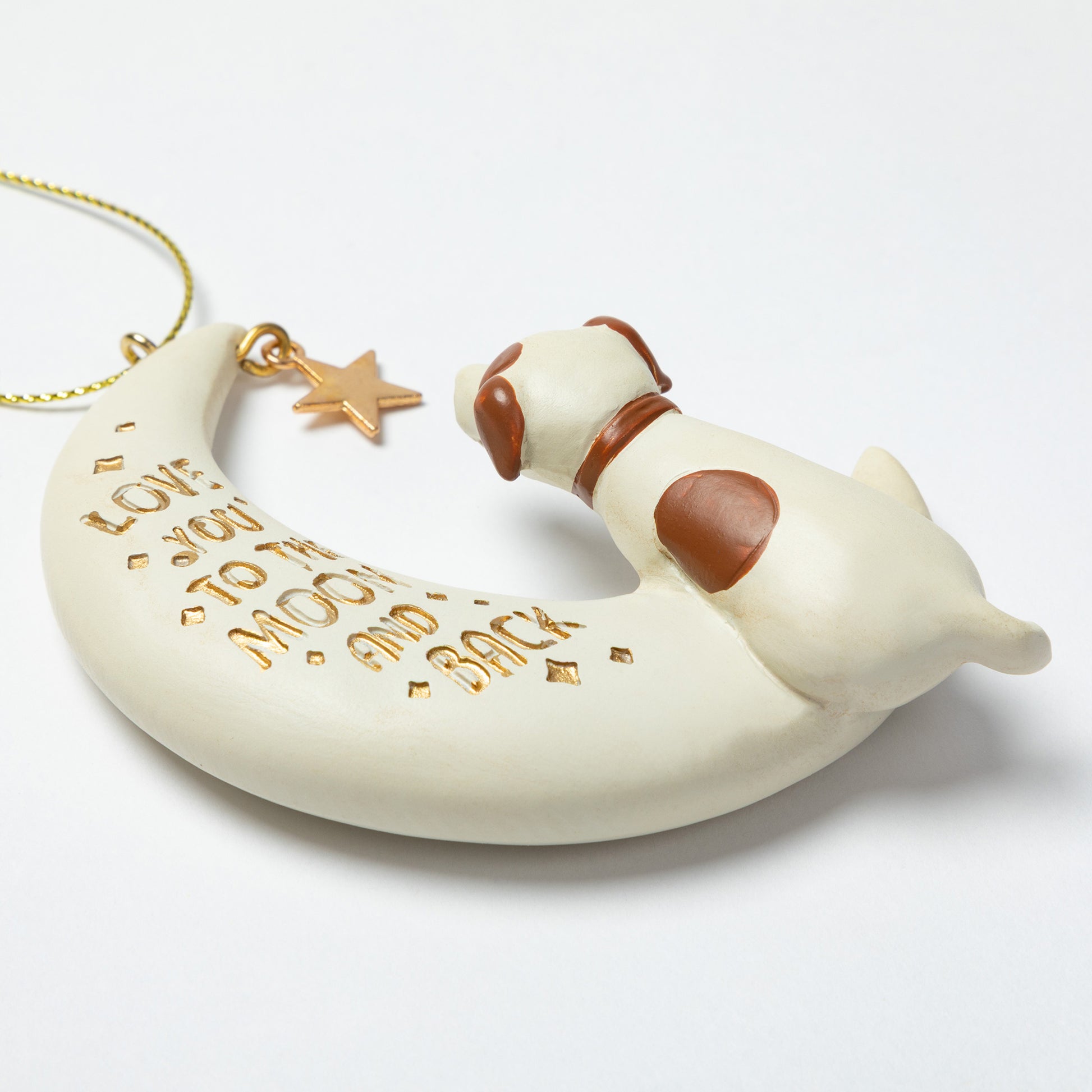 Dog-shaped ornament with 'I love you to the moon and back' text on a white background
