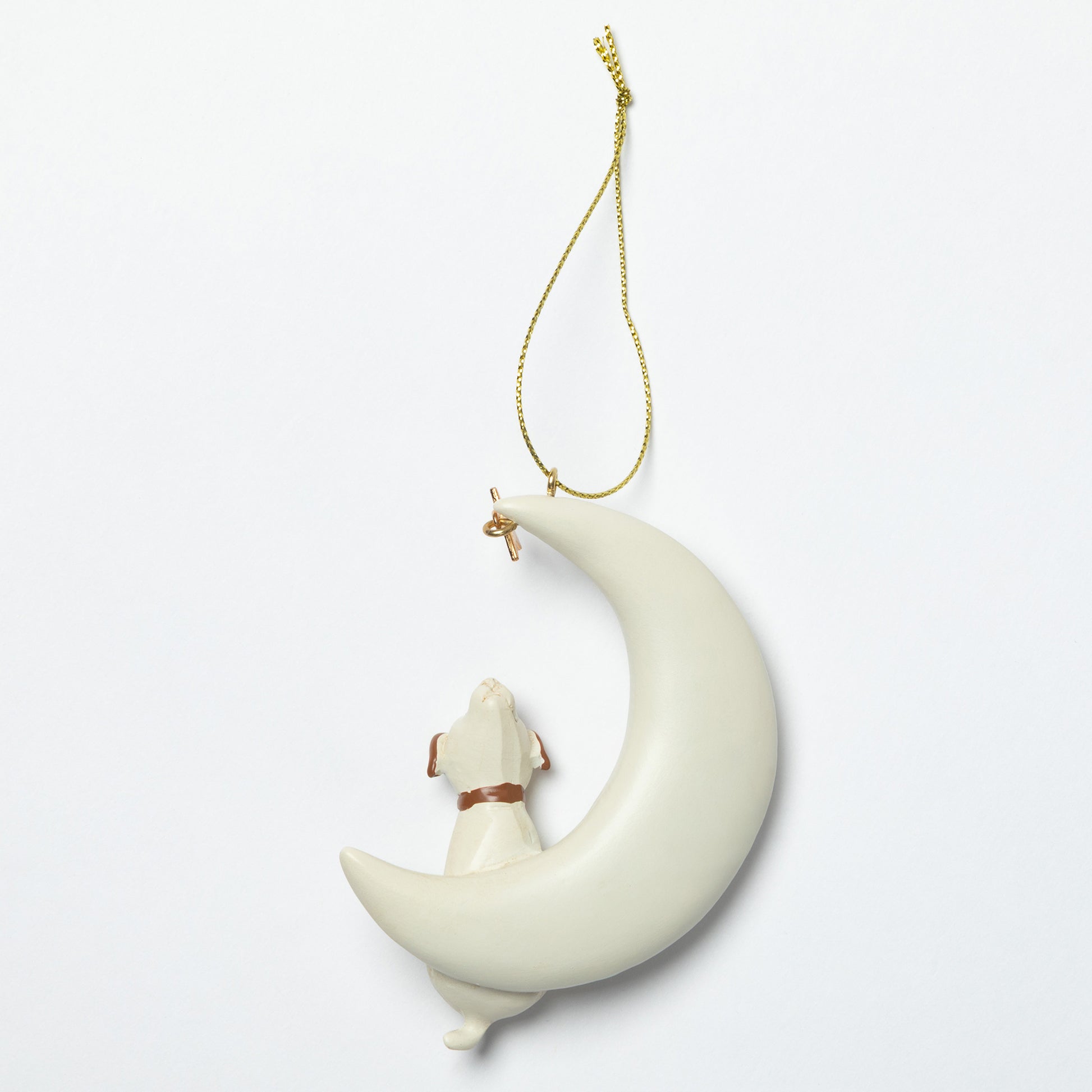 Decorative hanging ornament with a moon and dog design on a white background