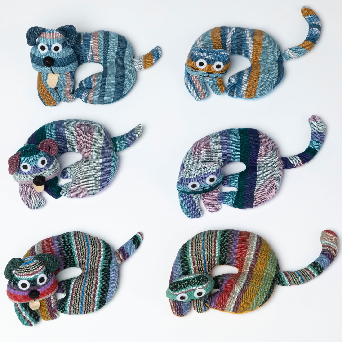 Cat-shaped and dog-shaped striped coaster/trivets on a white background