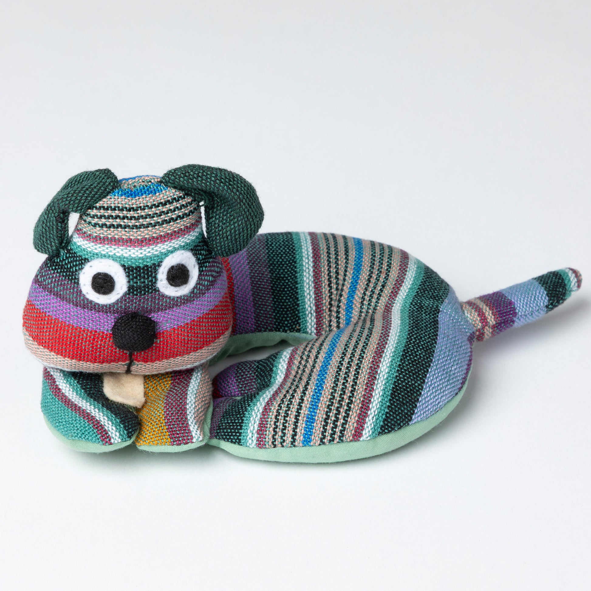 Colorful striped dog-shaped coaster on a white background