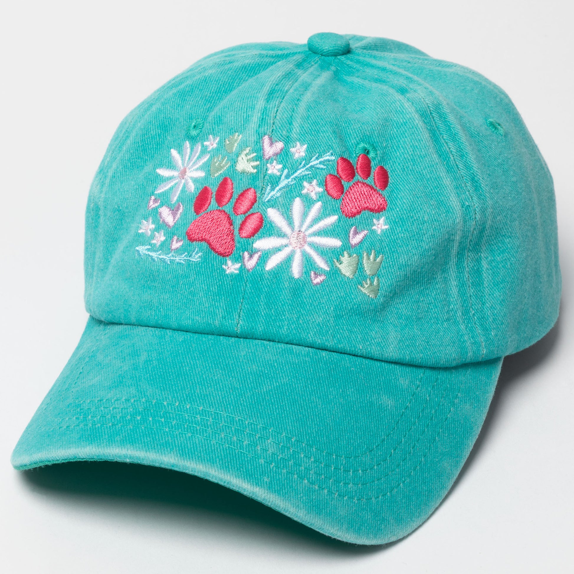 Turquoise cap with pink paw prints and white flowers on a light gray background