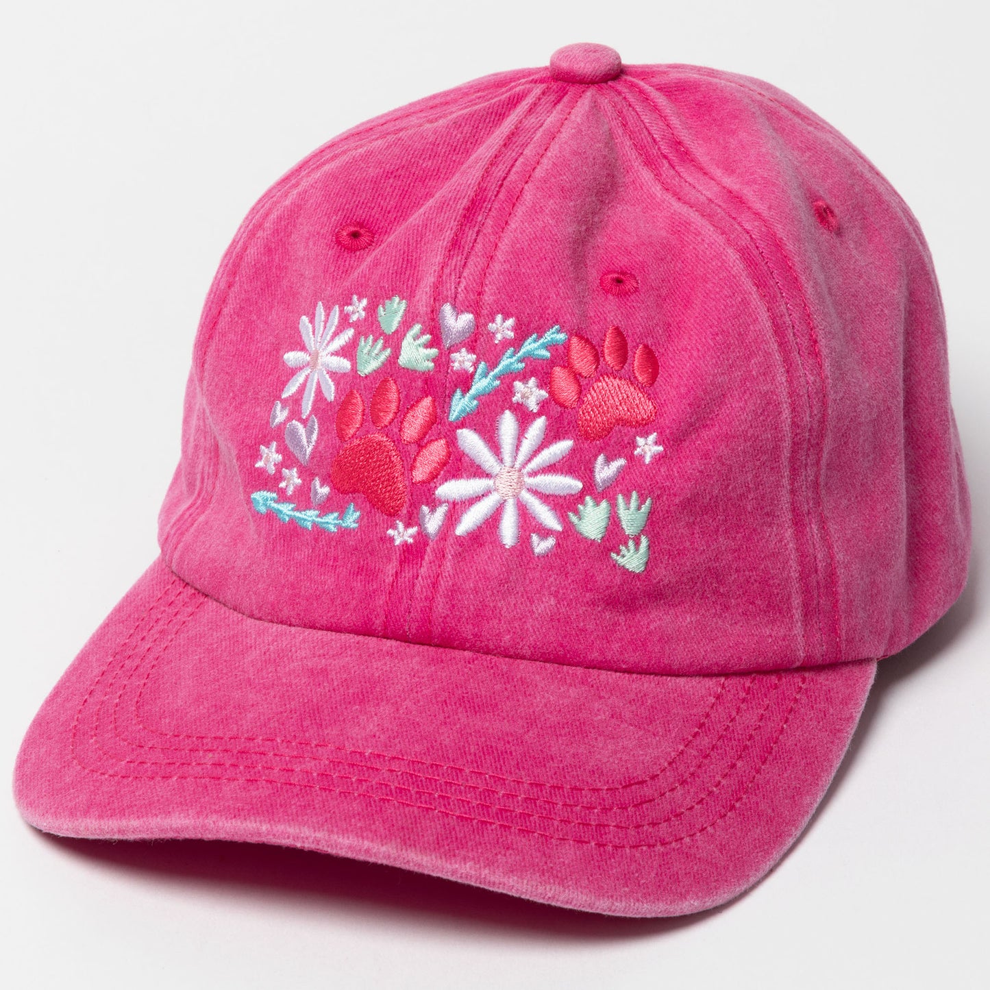 Pink cap with floral and paw print design on a white background
