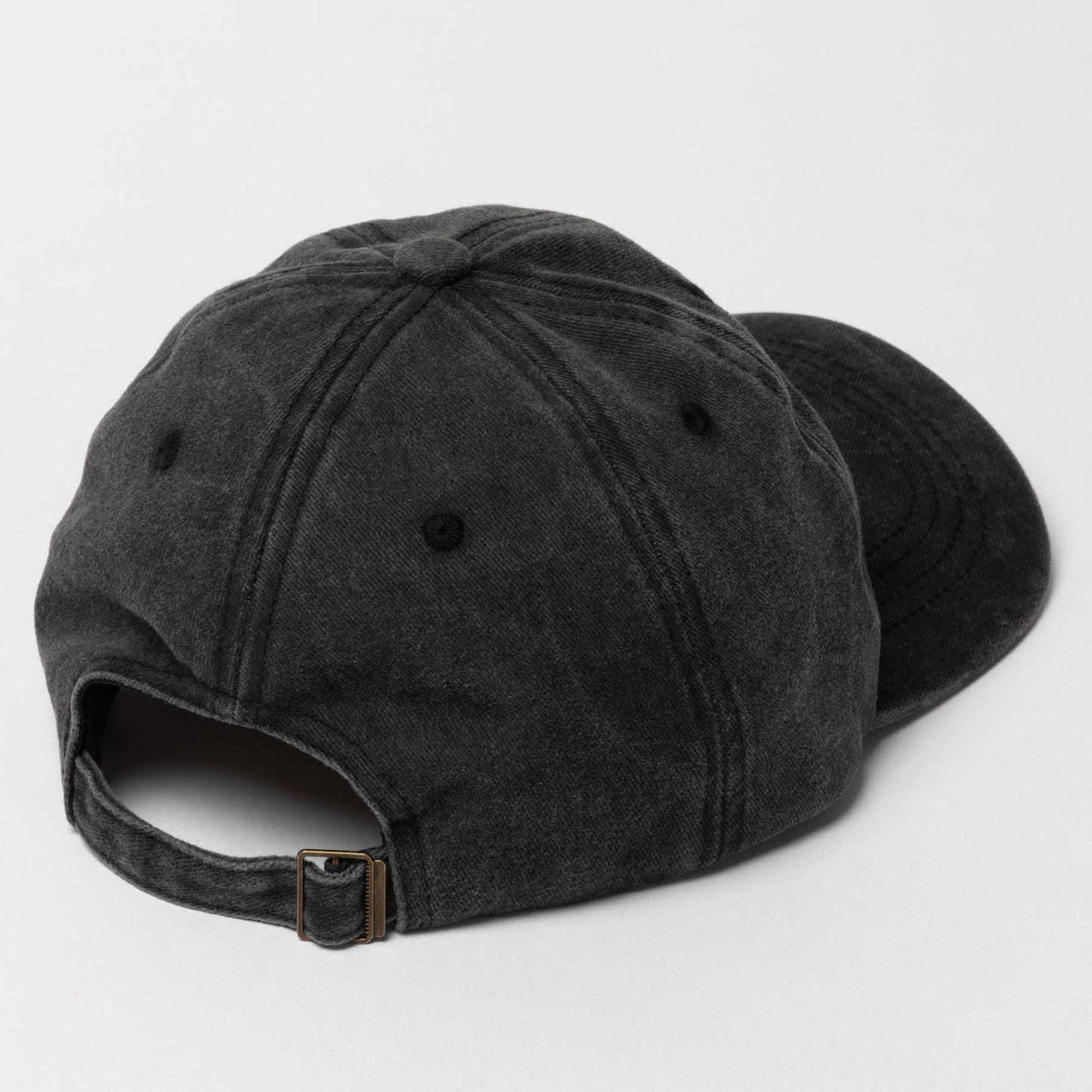 Black baseball cap on a light gray background
