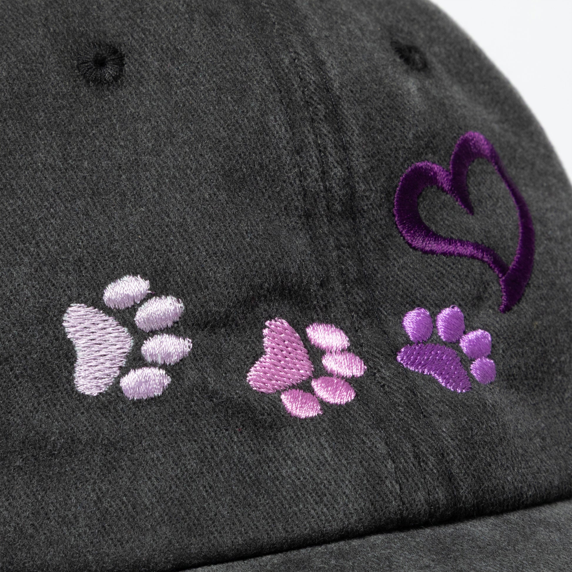 Gray cap with purple and pink paw prints and a heart design.