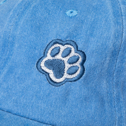 Blue baseball cap with navy blue paw print embroidered on the front