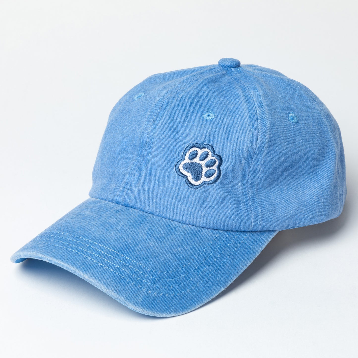 Blue baseball cap with navy blue paw print embroidered on the front