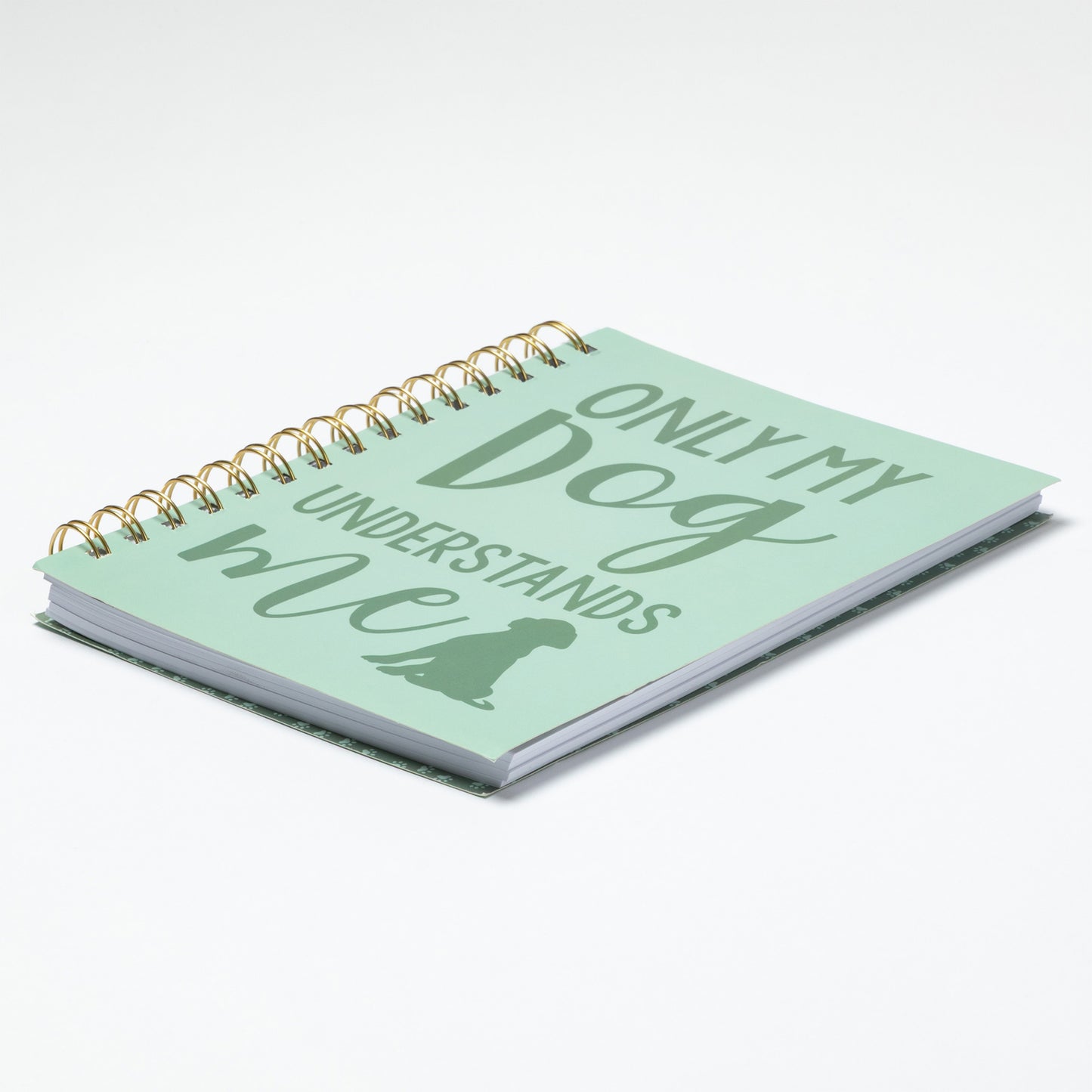 Light green notebook with 'Only my dog understands' text on a white background