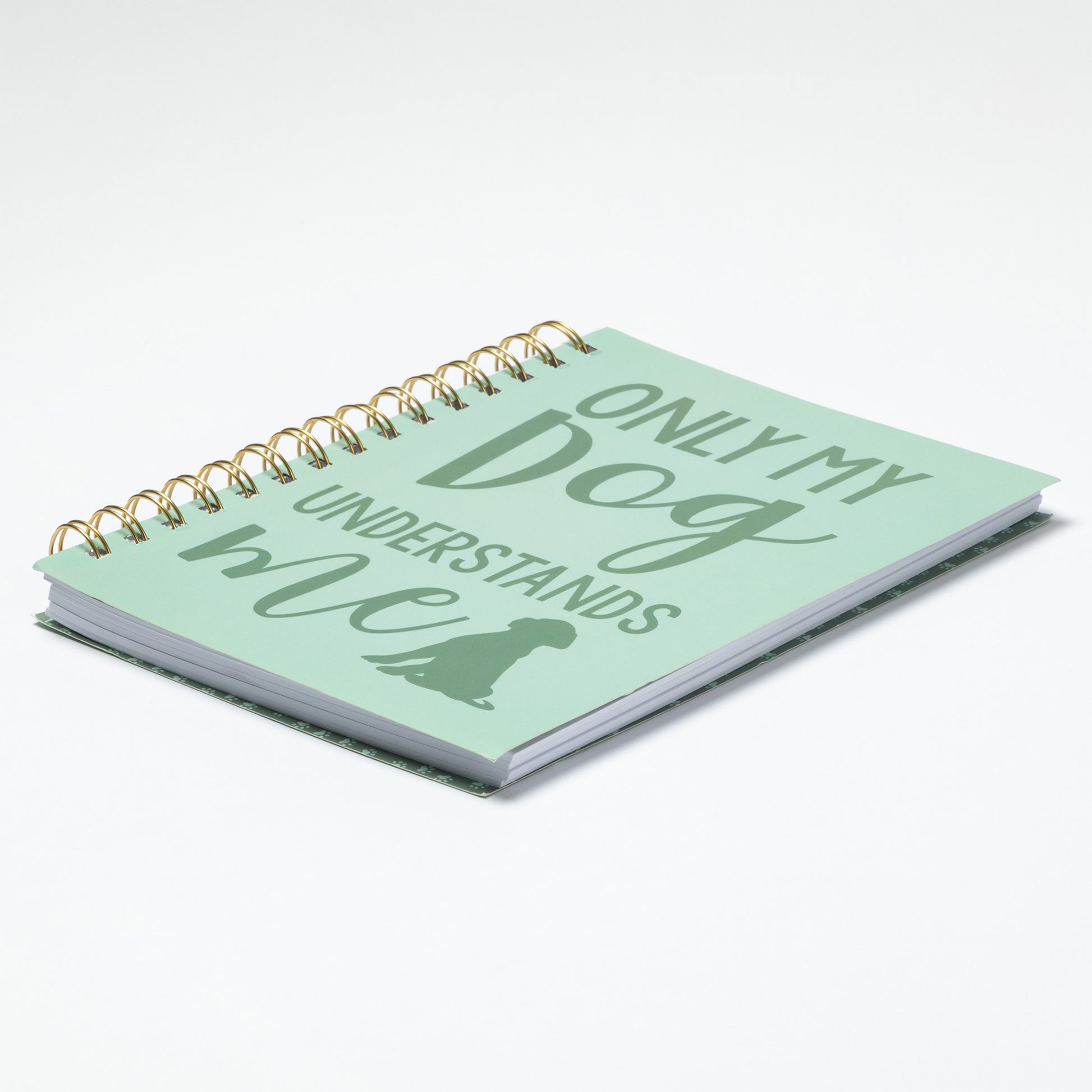 Light green notebook with 'Only my dog understands' text on a white background