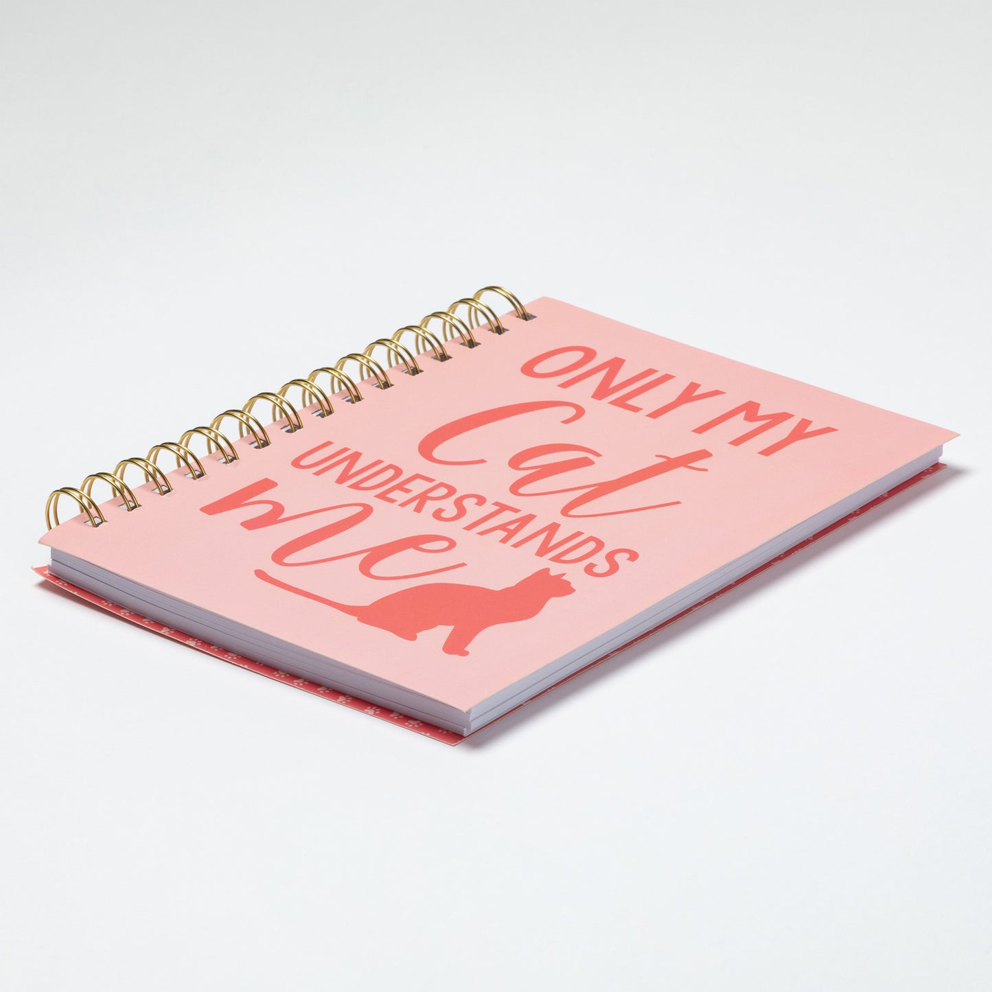Pink notebook with 'Only my cat understands me' text and cat illustration on a white background