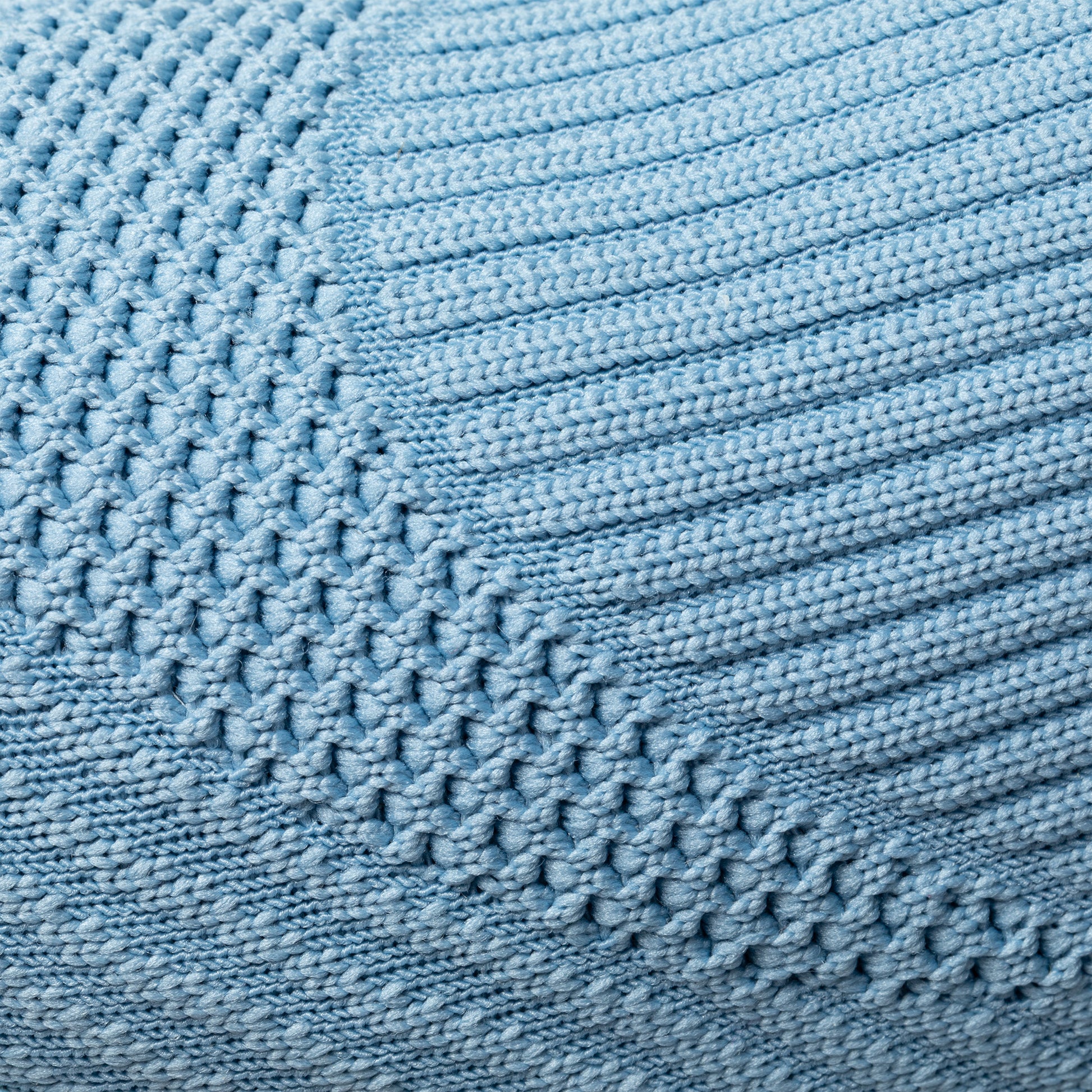 Close-up of a textured blue knitted upper with a woven pattern