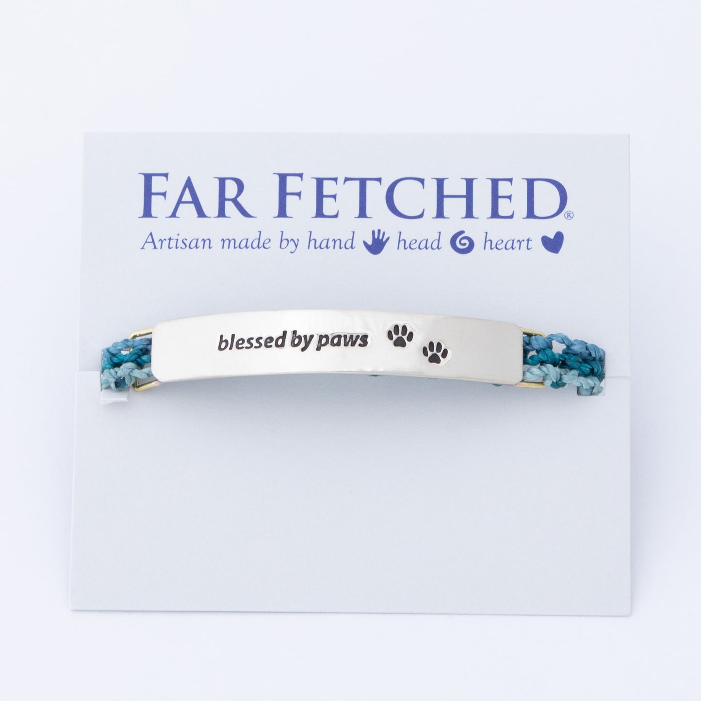 Bracelet with 'blessed by paws' text on a 'Far Fetched' branded card, against a white background.