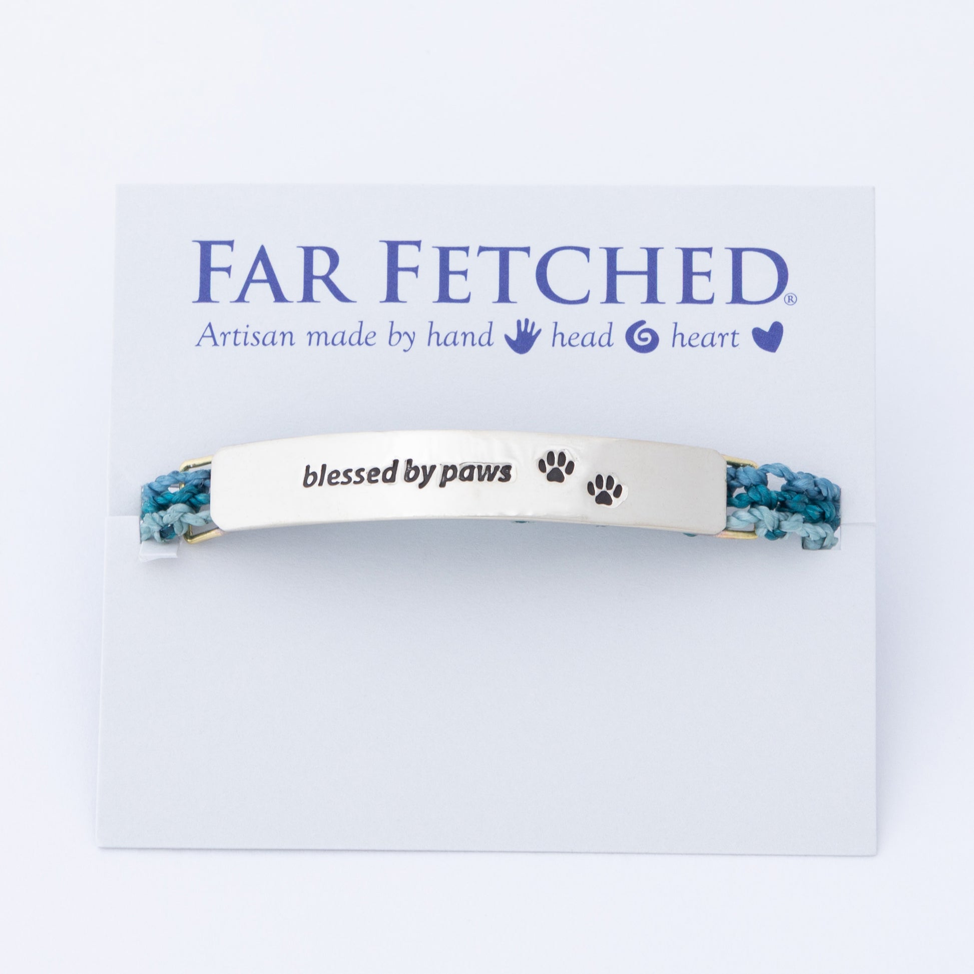 Bracelet with 'blessed by paws' text on a 'Far Fetched' branded card, against a white background.