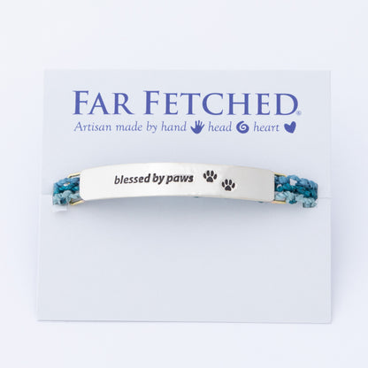Bracelet with 'blessed by paws' text on a 'Far Fetched' branded card, against a white background.