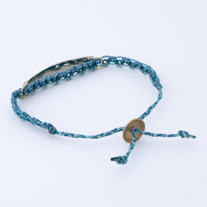 Blue braided bracelet with a gold clasp on a white background