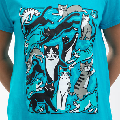 Illustration of playful cats in various poses on a bright blue t-shirt.