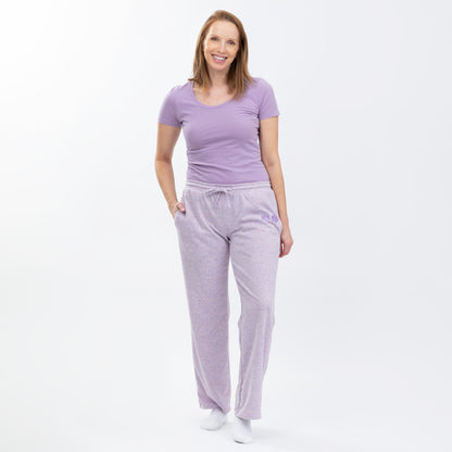 Woman wearing a purple tee with purple rib knit soft relaxed fit pants on a white background.