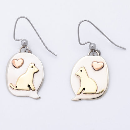 Pair of earrings with dog and heart designs on a light background