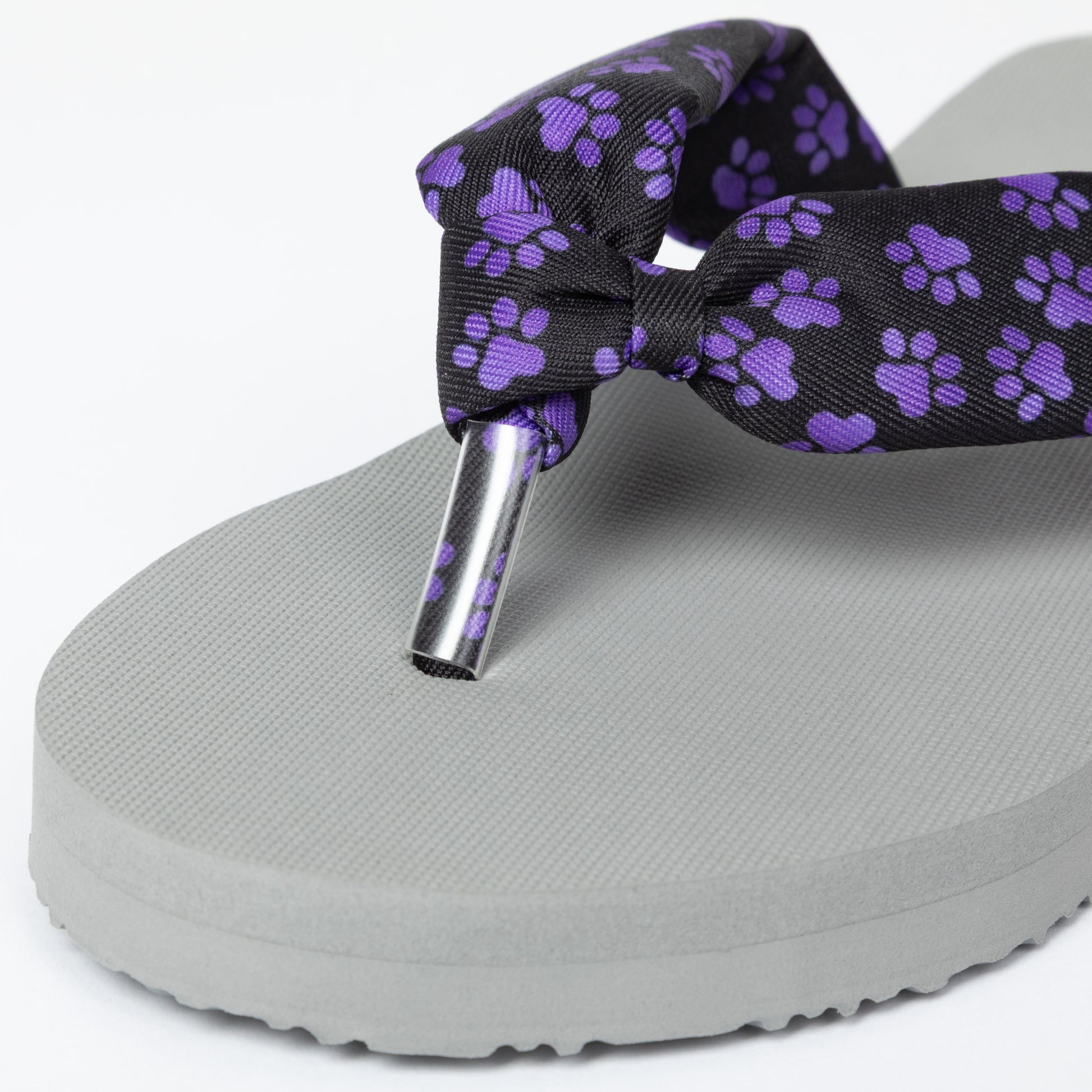 Gray sandal with a purple paw print strap, including a toe protector on a white background
