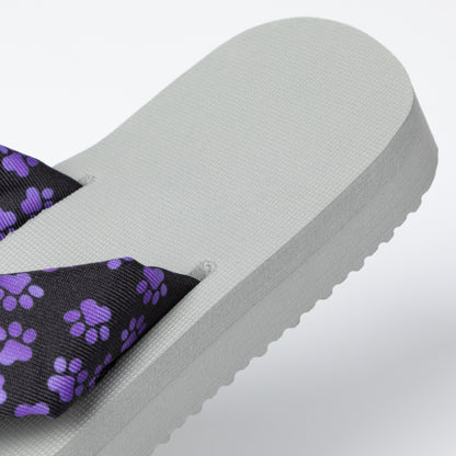 Gray sandal with purple paw print strap on a light gray background