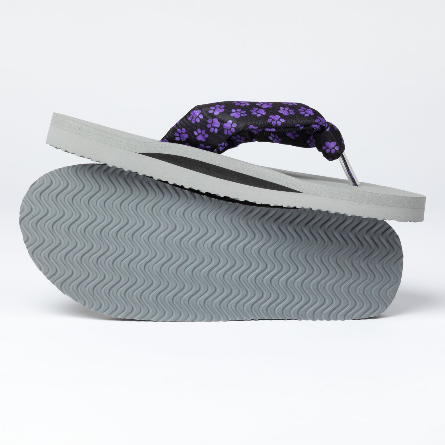 Flip-flop with purple paw print design on a white background