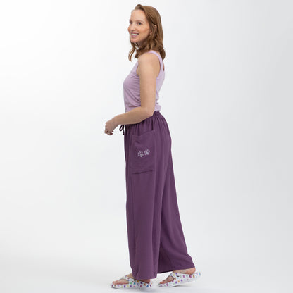 Woman wearing a purple outfit with a white background