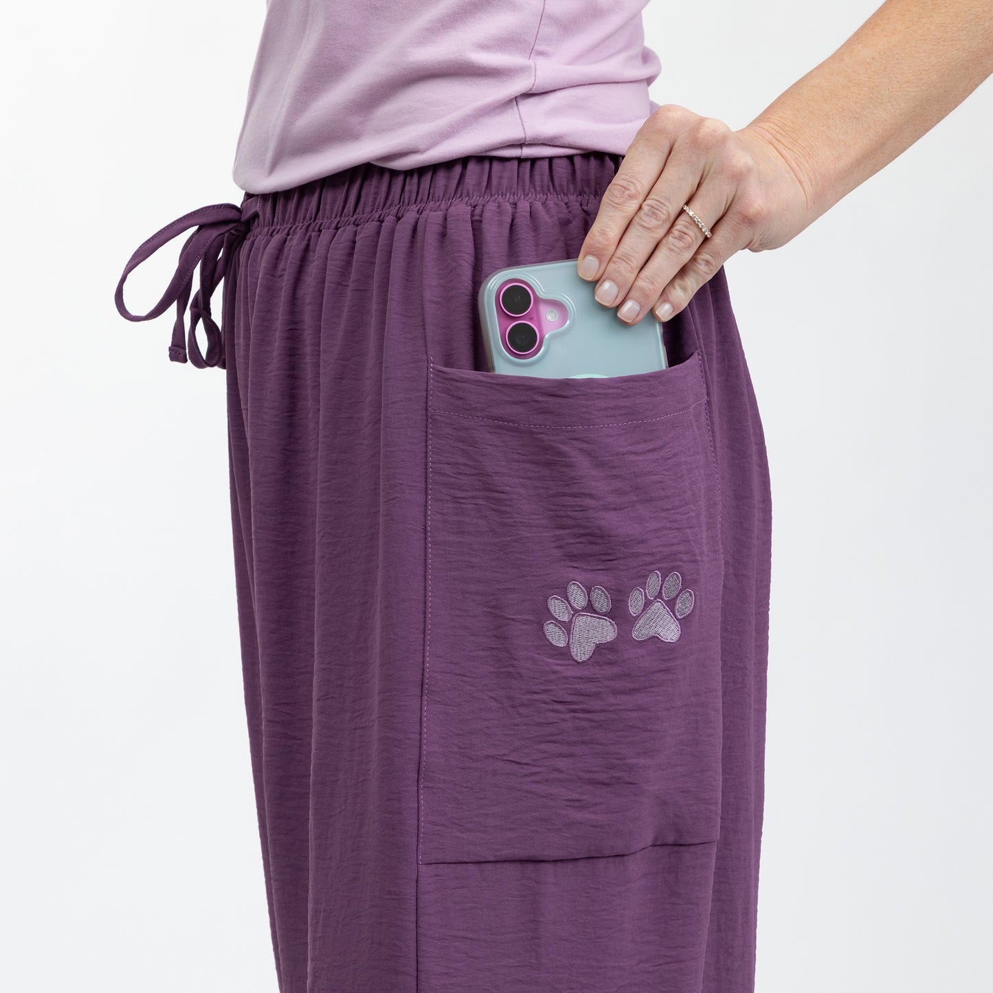 Purple pants with paw prints on a white background