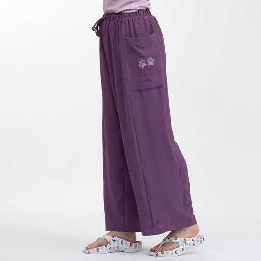 Purple pants with a paw print pocket on a white background