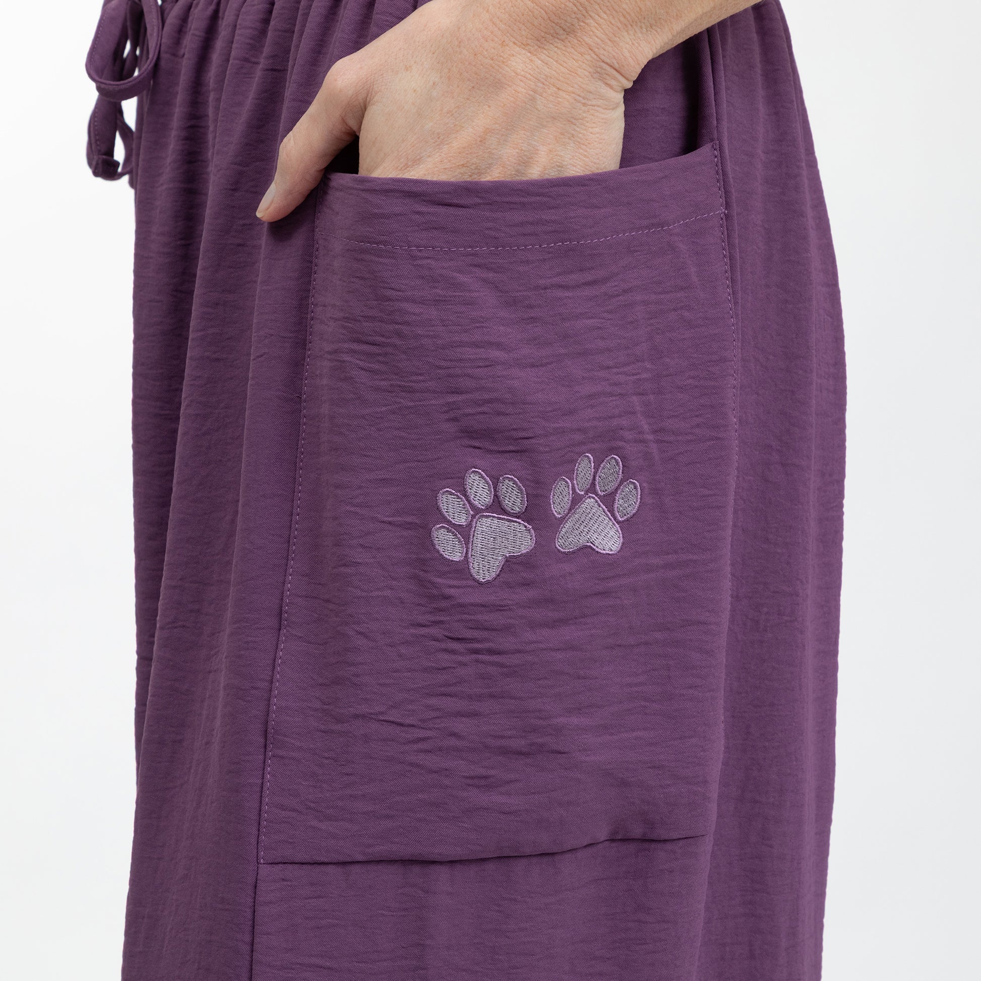 Purple pants with paw print design on a white background