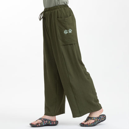 Green wide-leg pants with a paw print on a white background