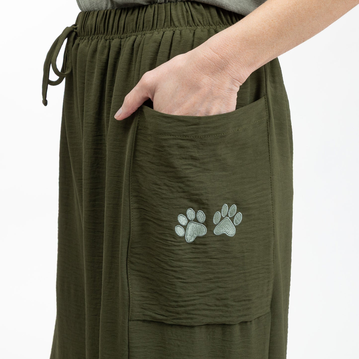 Green pants with paw print design on a white background
