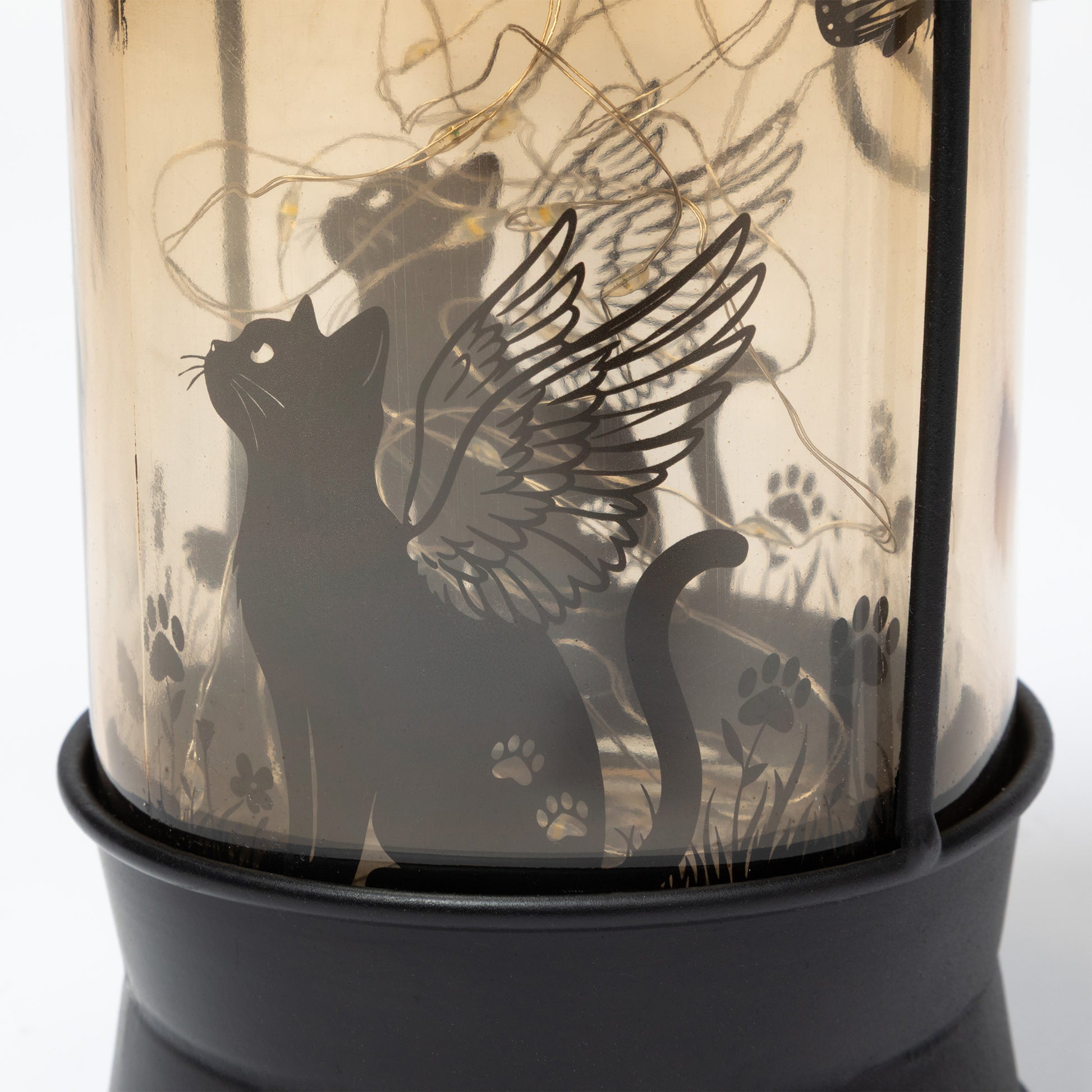 Decorative lantern with a black cat silhouette and wings design.