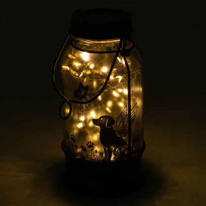 Decorative jar lantern with LED lights and a dog silhouette on a dark background