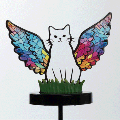 Cat silhouette with mosaic angel wings on a garden stake, with the background going from white to black, showing the soft light glowing.