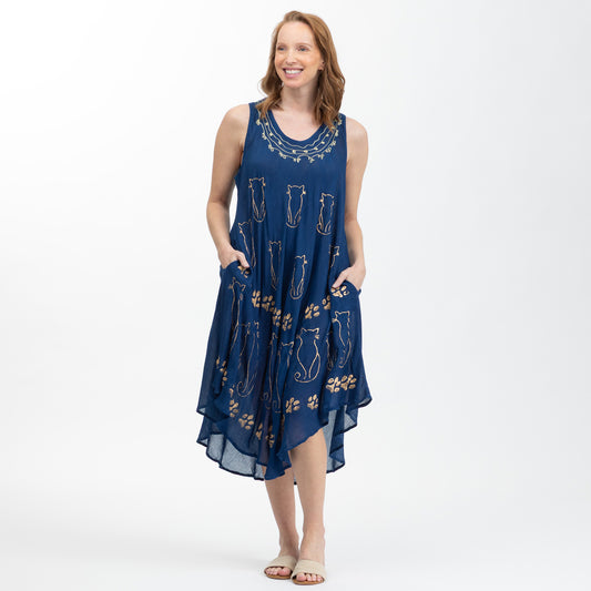 Woman wearing a blue dress with cat pattern on a white background