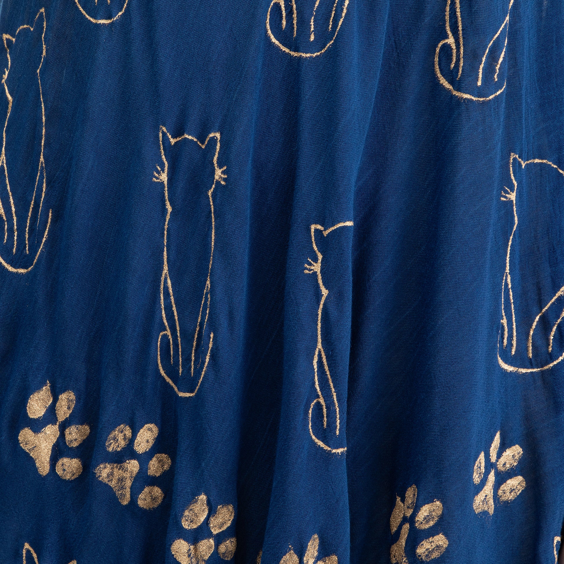 Navy blue fabric with gold cat and paw print patterns