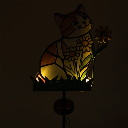 Decorative solar stake with a cat and flower design in stained glass style, glowing in the dark.