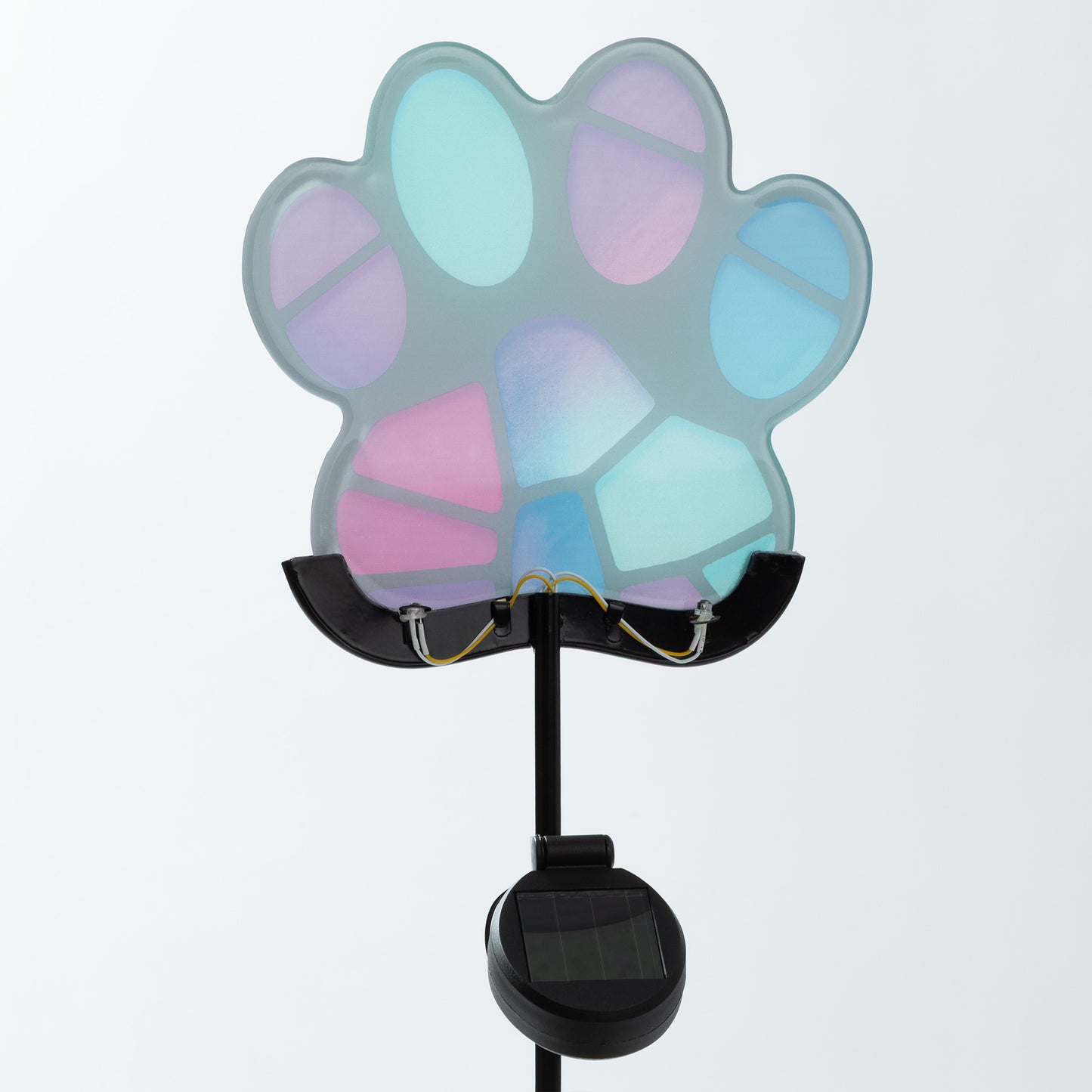 Colorful paw-shaped solar light on a white background
