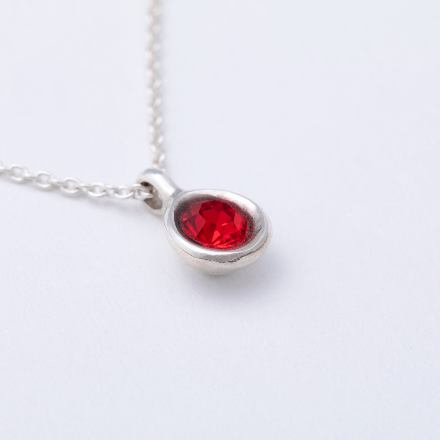 Pearl earring with silver and diamond accents on a white background