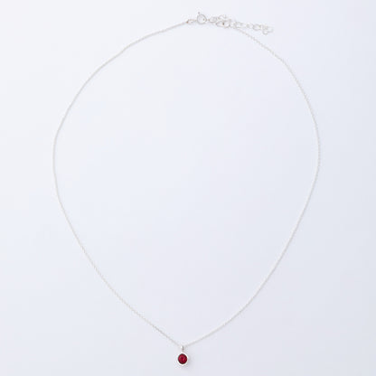 Necklace with a red pendant on a white background