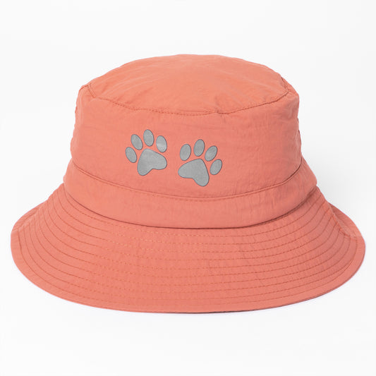 Coral bucket hat with paw prints on a white background