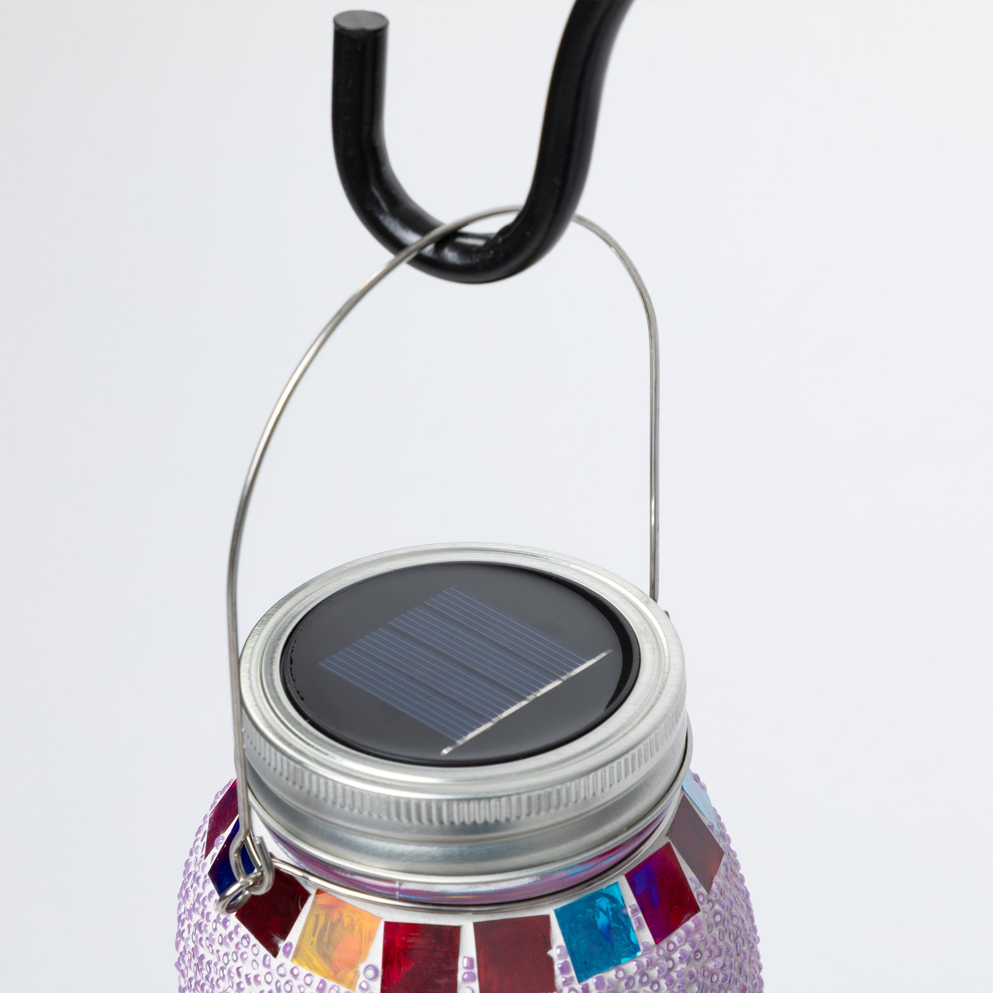 Solar-powered lantern with colorful design on a white background