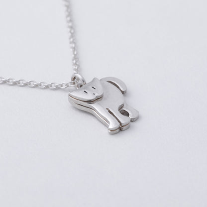 Silver horse-shaped pendant on a chain against a light gray background