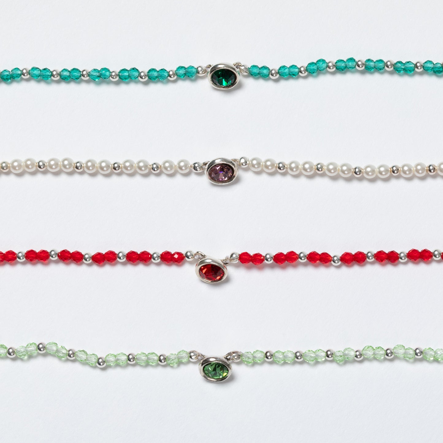 Four beaded necklaces with gemstones on a white background