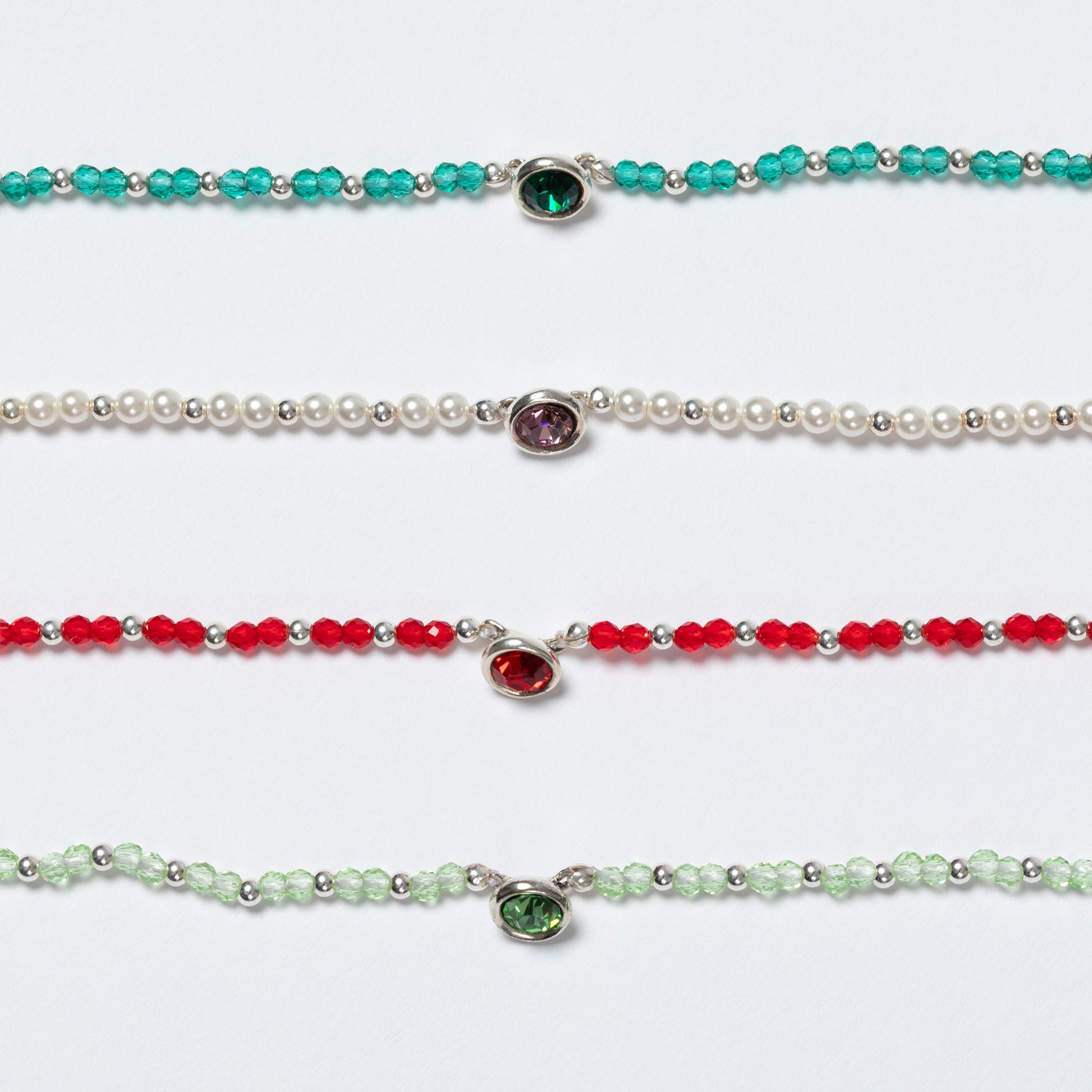 Four beaded necklaces with gemstones on a white background