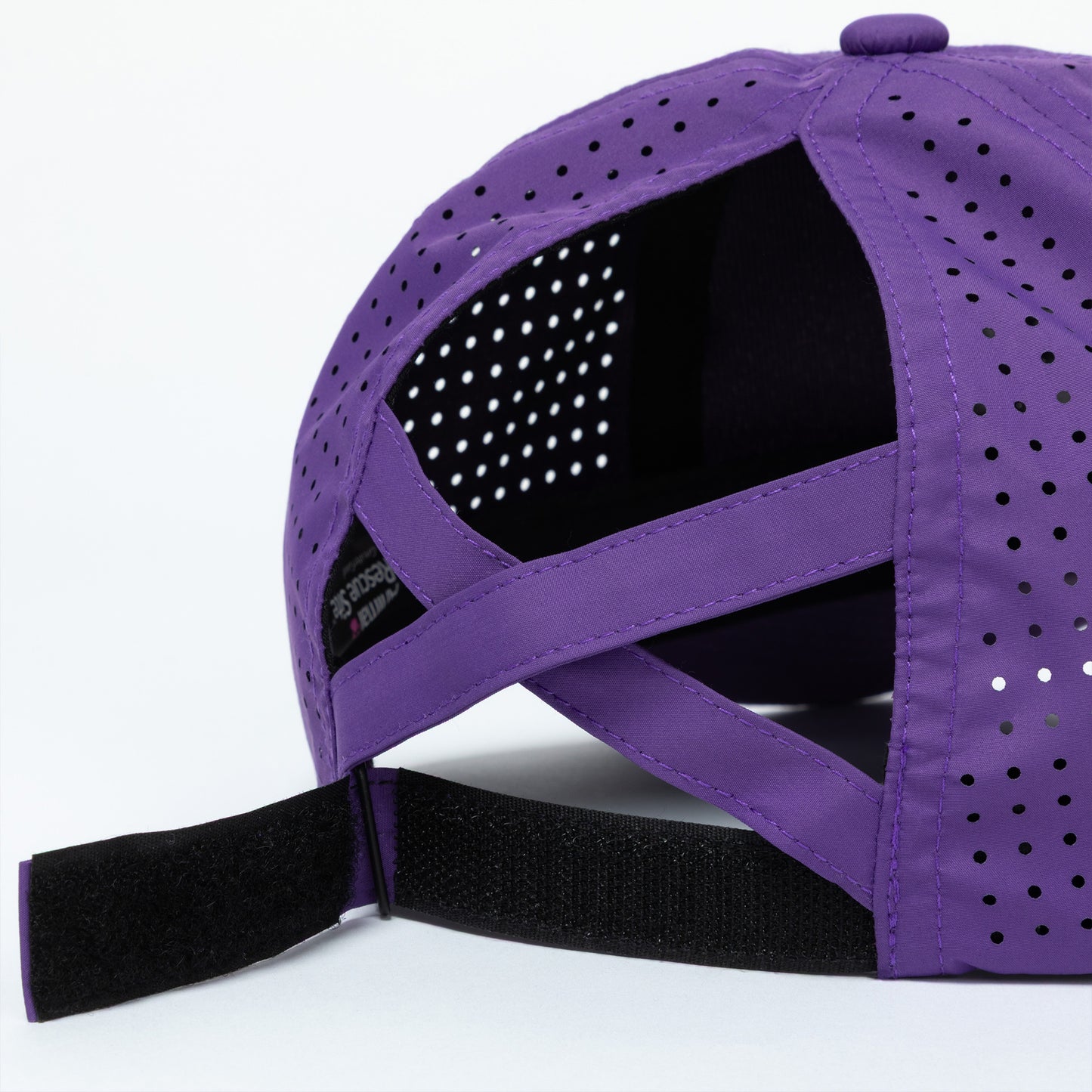 Purple cap with mesh back, adjustable strap, and ponytail opening on a white background