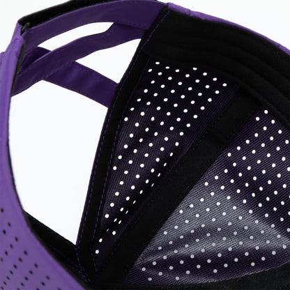 Close-up of perforated fabric on a purple sporty hat, on a white background