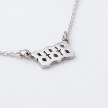 Silver necklace with a pendant on a white background
