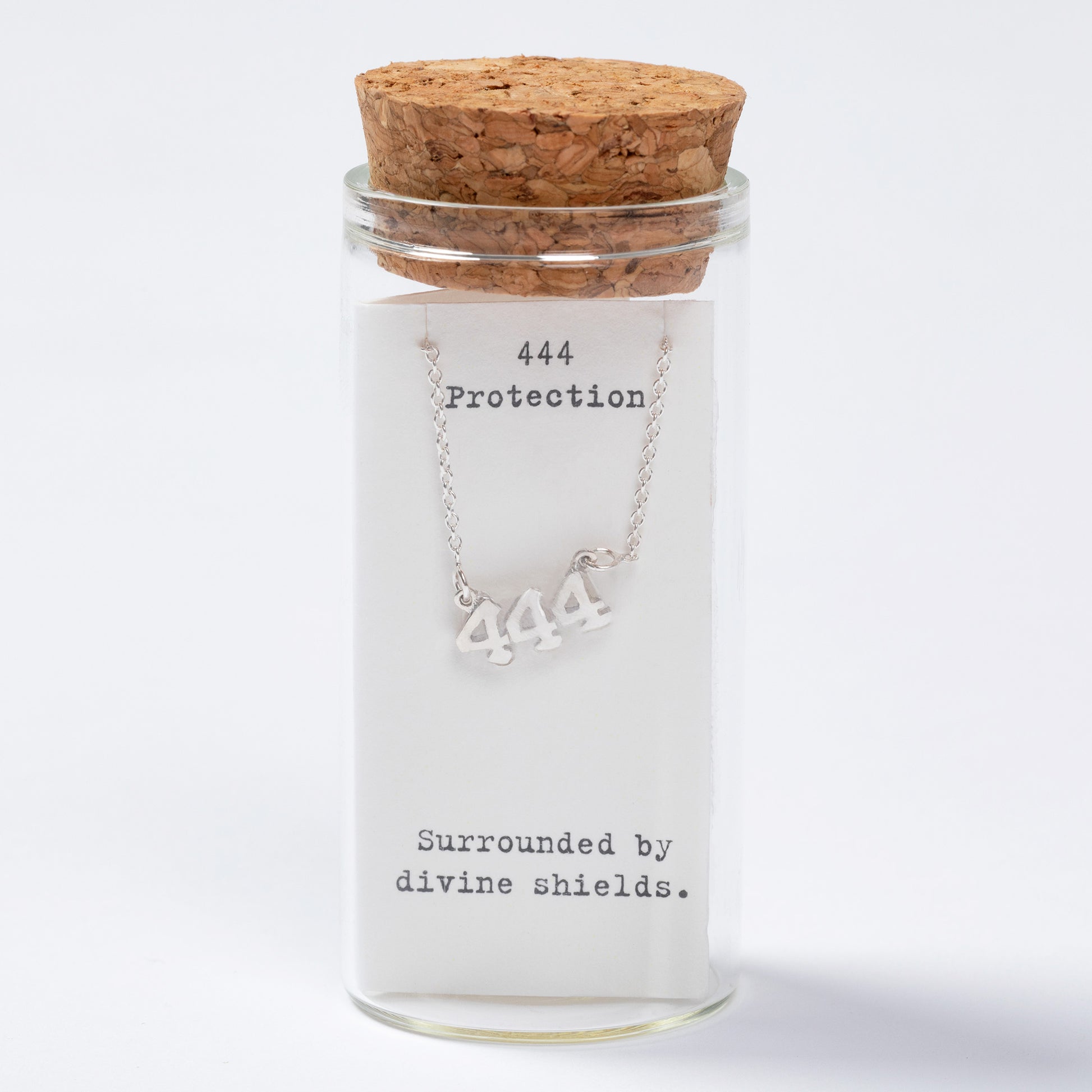 Necklace with '444' symbol in a glass jar labeled 'Protection' on a white background